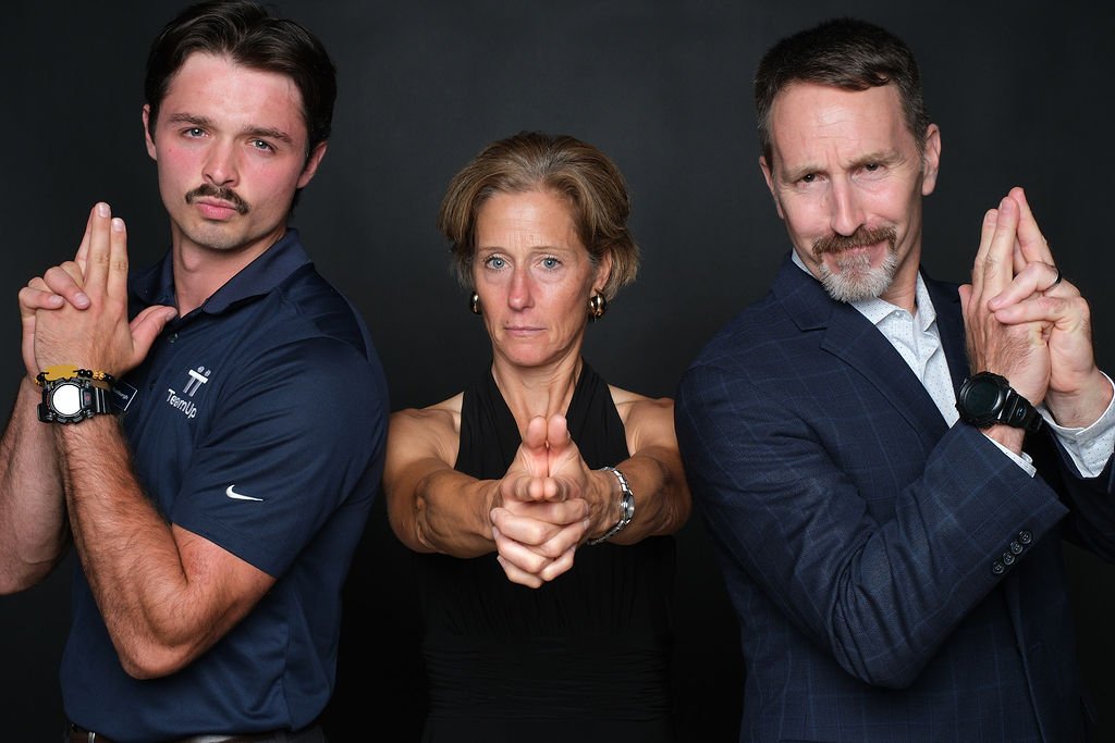 Three colleagues clowning for the camera at the event portrait booth