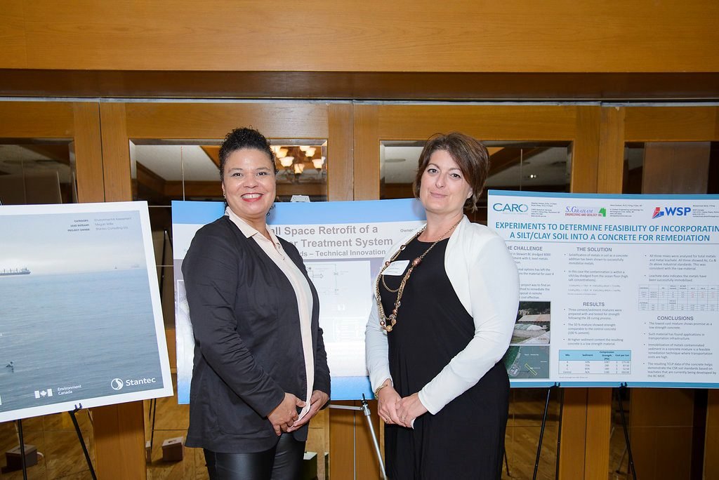 Delegates reading technical poster displays at an environmental industry event in Vancouver