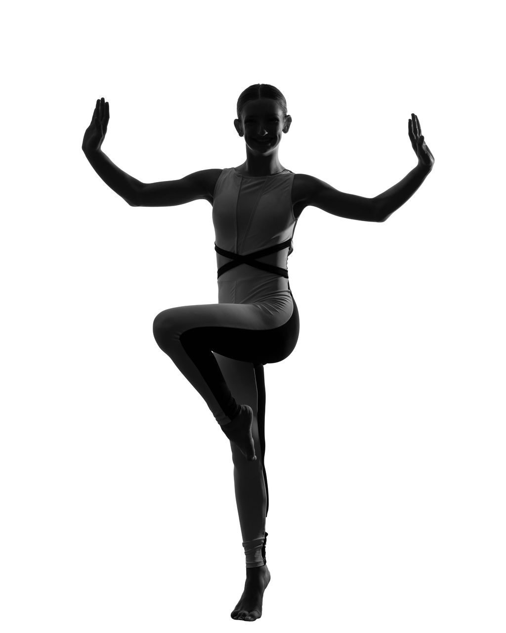 Dance portrait in a black leotard showing balance and extension