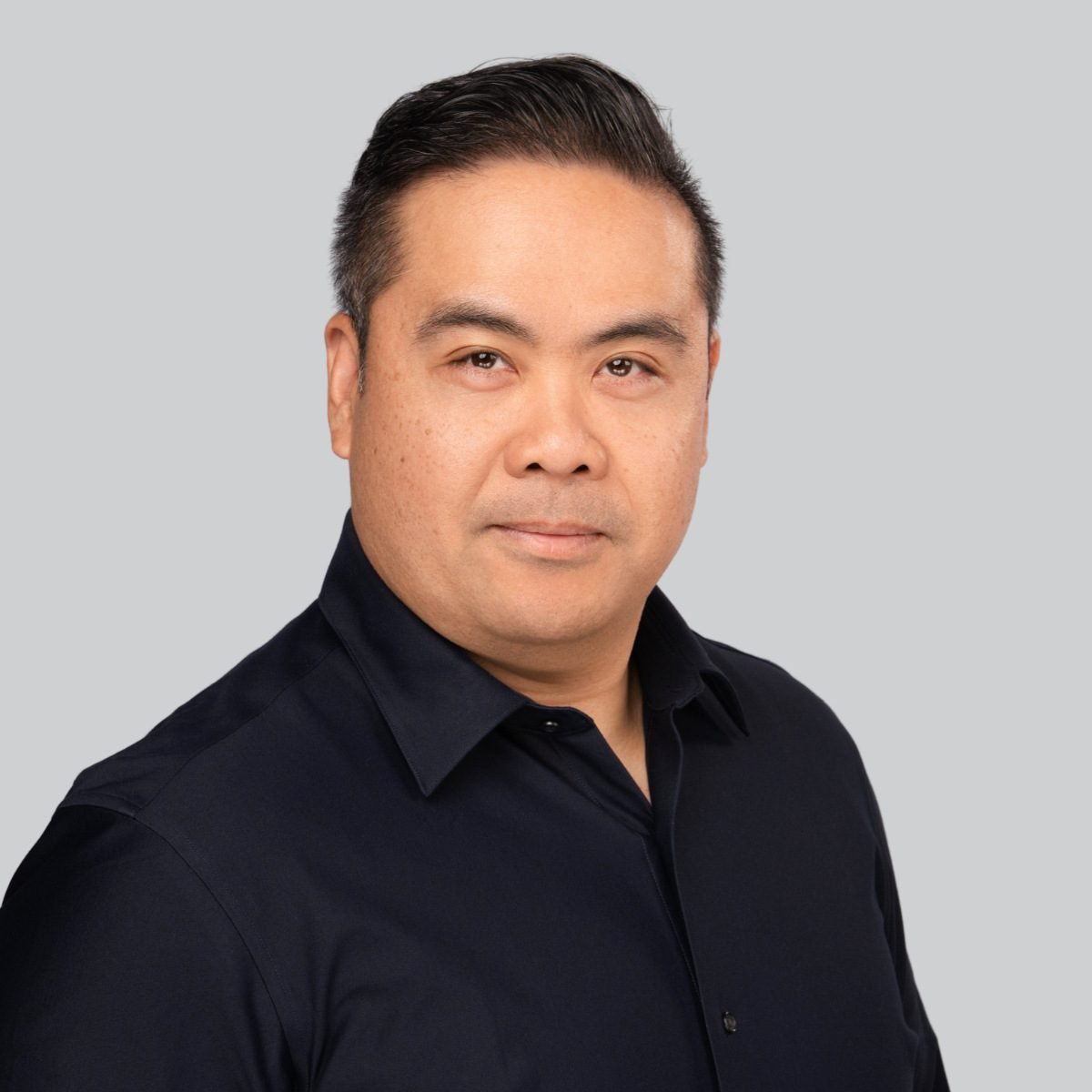 Event headshot booth portrait of a man in a black shirt