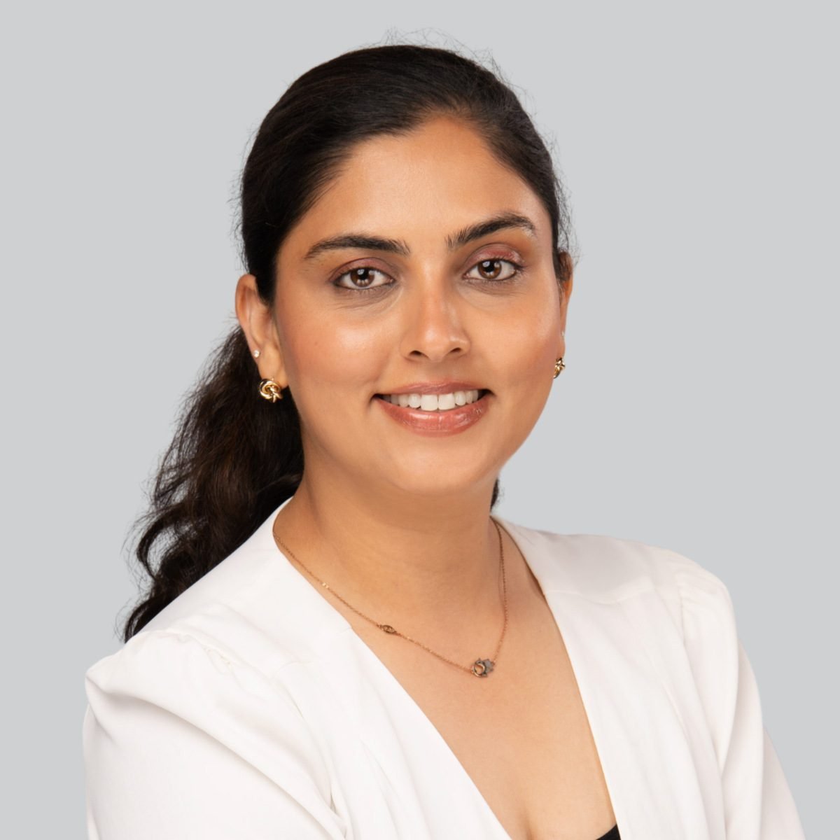 Event headshot booth portrait of a woman in a white blazer