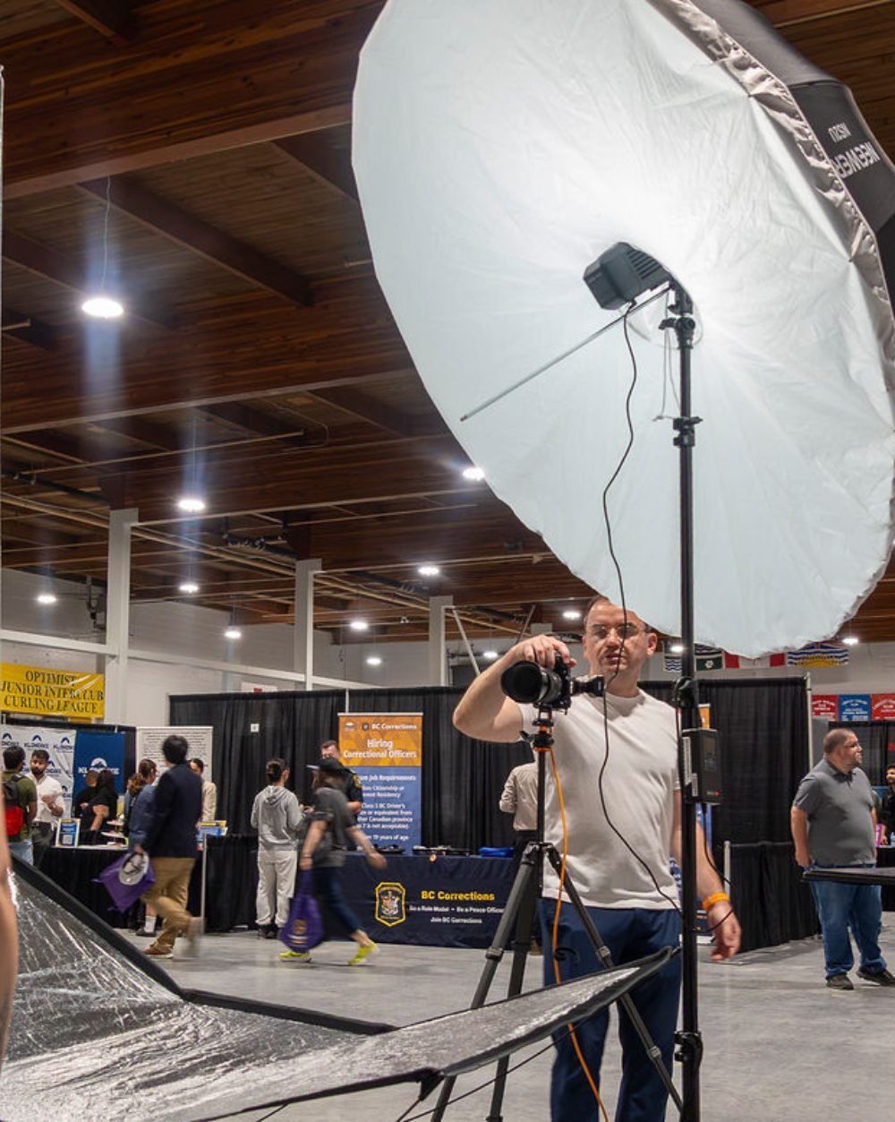Headshot booth set up on a Vancouver expo floor with lighting and a white backdrop