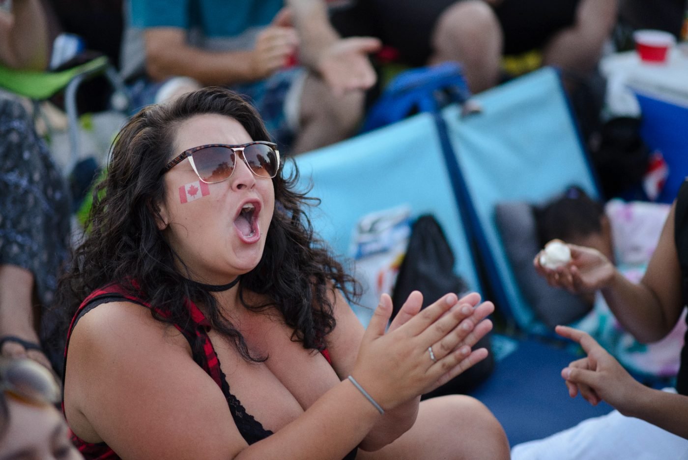 Festival-goer clapping and cheering from the crowd during a performance