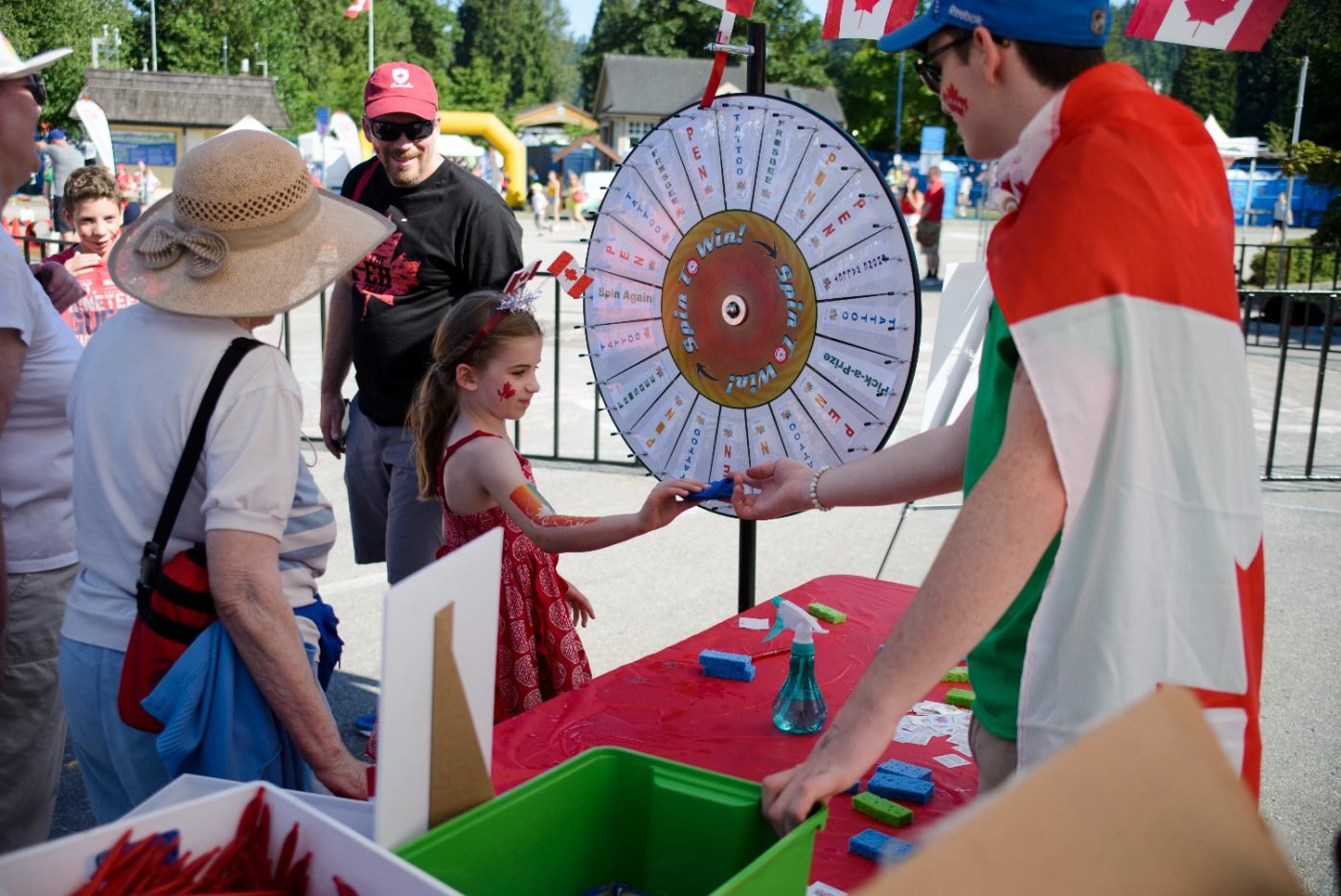 Children spinning a prize wheel at a community festival games booth