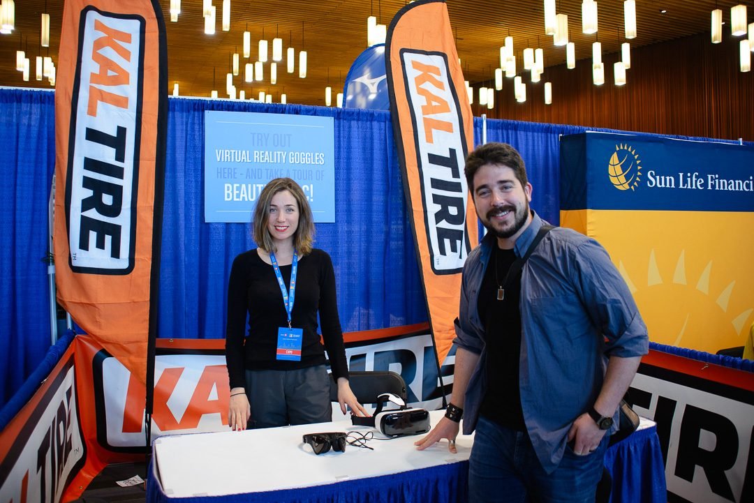 Sponsor activation booth staff photographed at a race expo, with branding clearly in frame