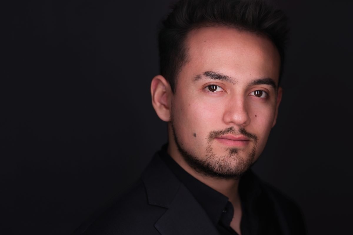 Actor headshot of Sebastian photographed on a dark backdrop in Vancouver