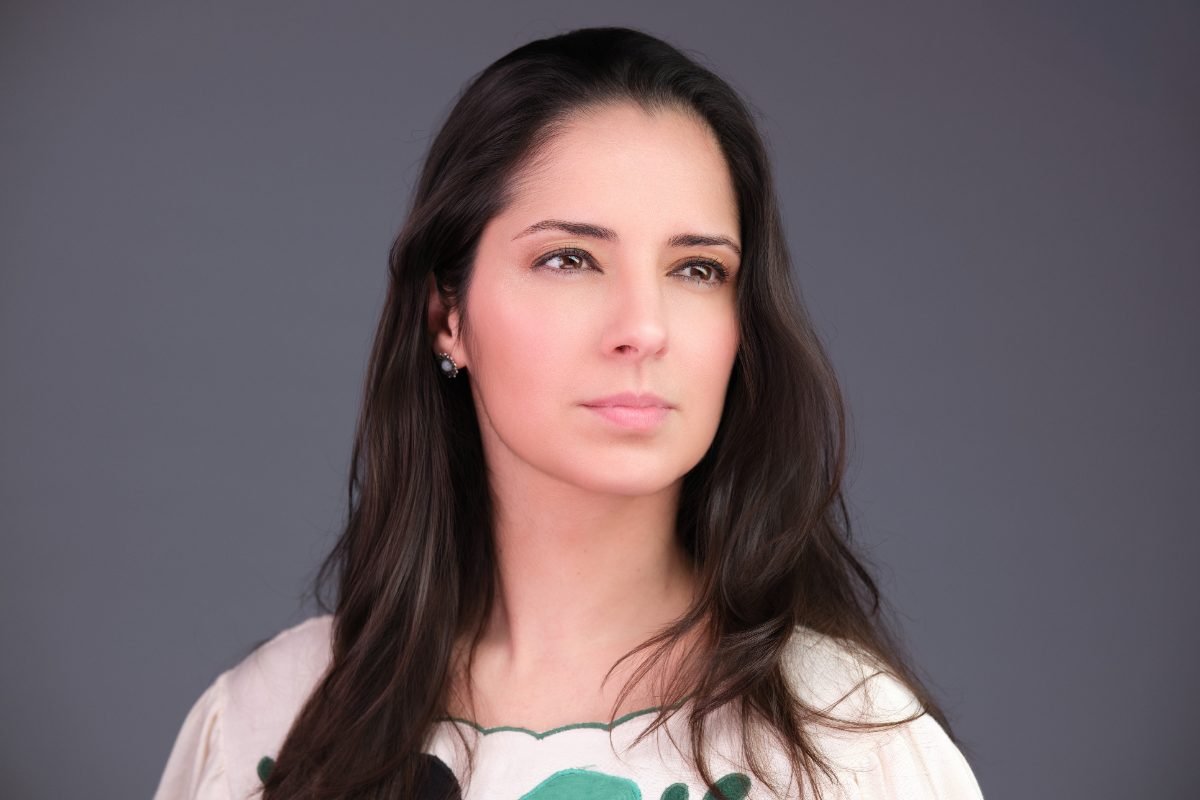 Business headshot of Julia Coutinho photographed on a light backdrop