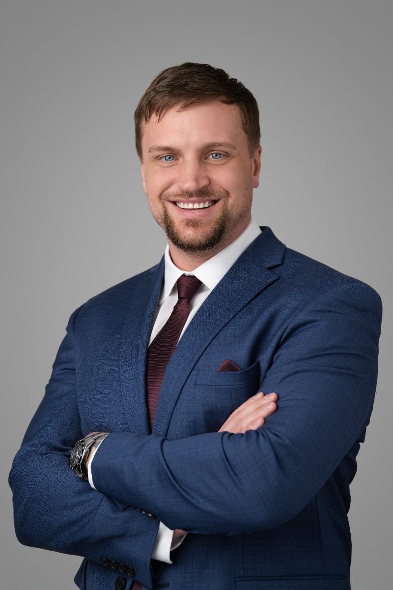 Realtor headshot of Lucas Plonka in a navy suit for signage and MLS listings