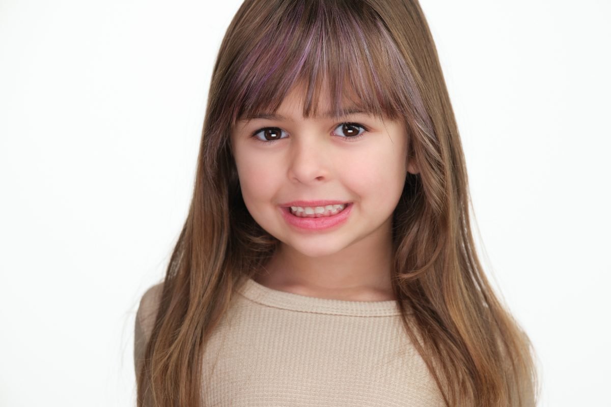 Child model headshot photographed on a white background in Langley BC