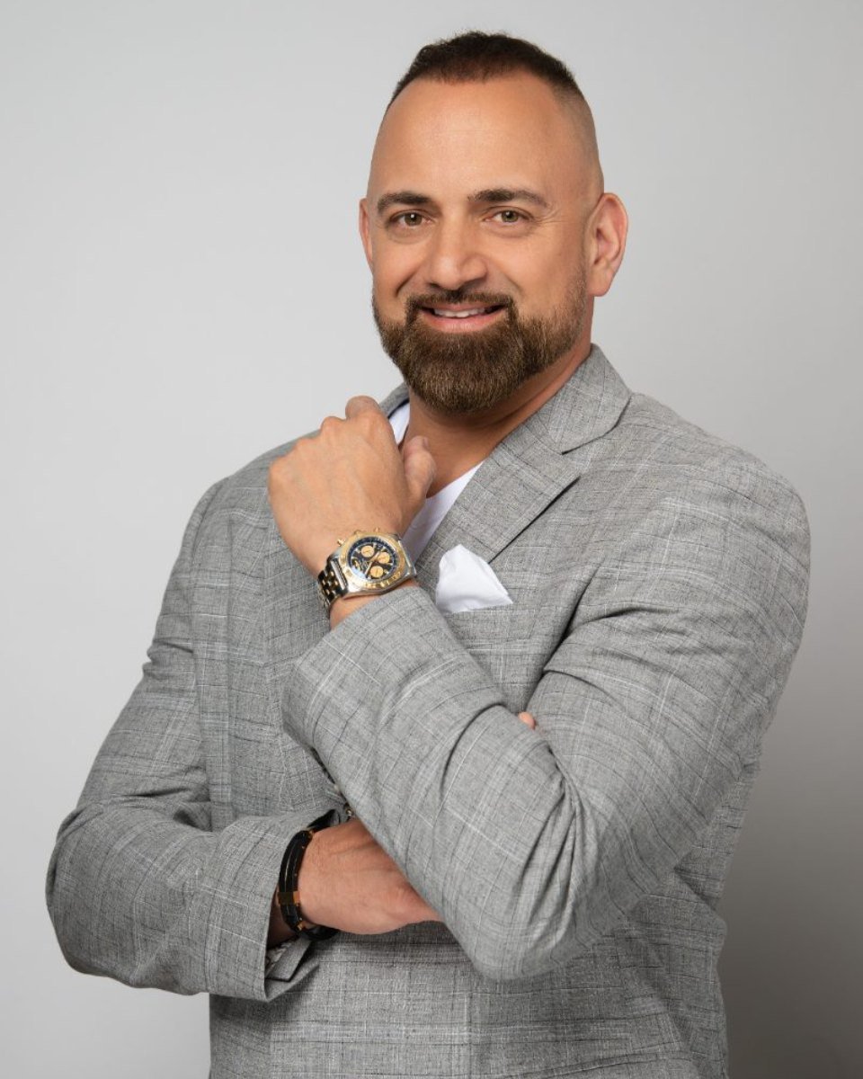 Personal branding headshot of a man in a grey blazer, Langley studio