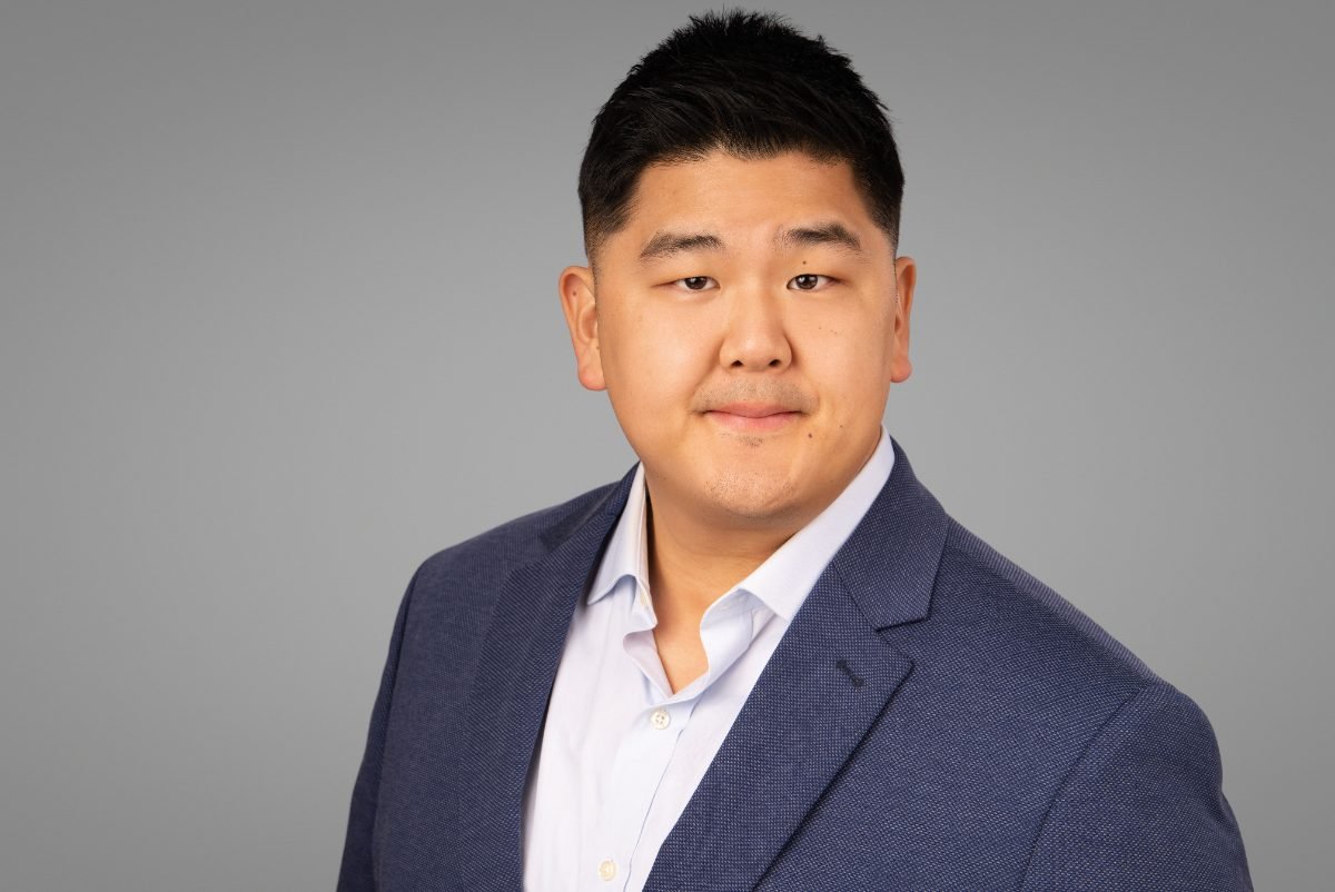 Professional headshot of Andy Yoo on a grey studio backdrop, Fraser Valley