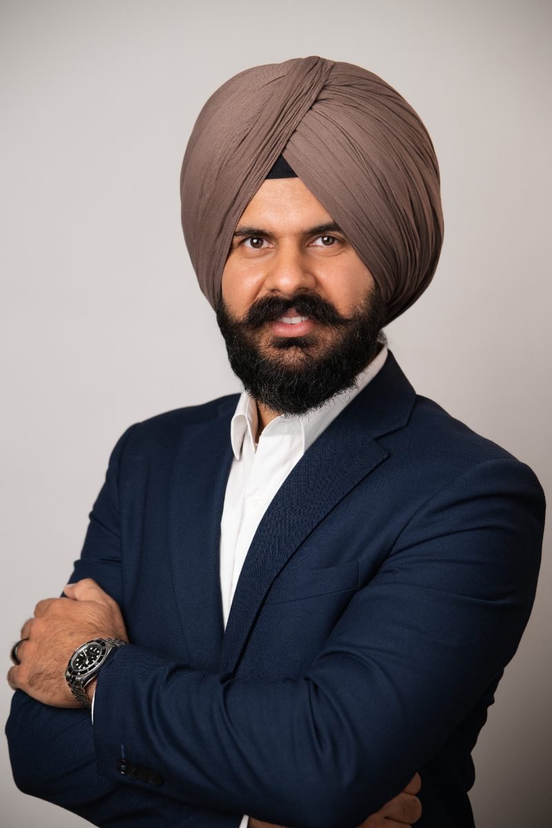 Professional headshot of Chand Karwal photographed on a light studio backdrop