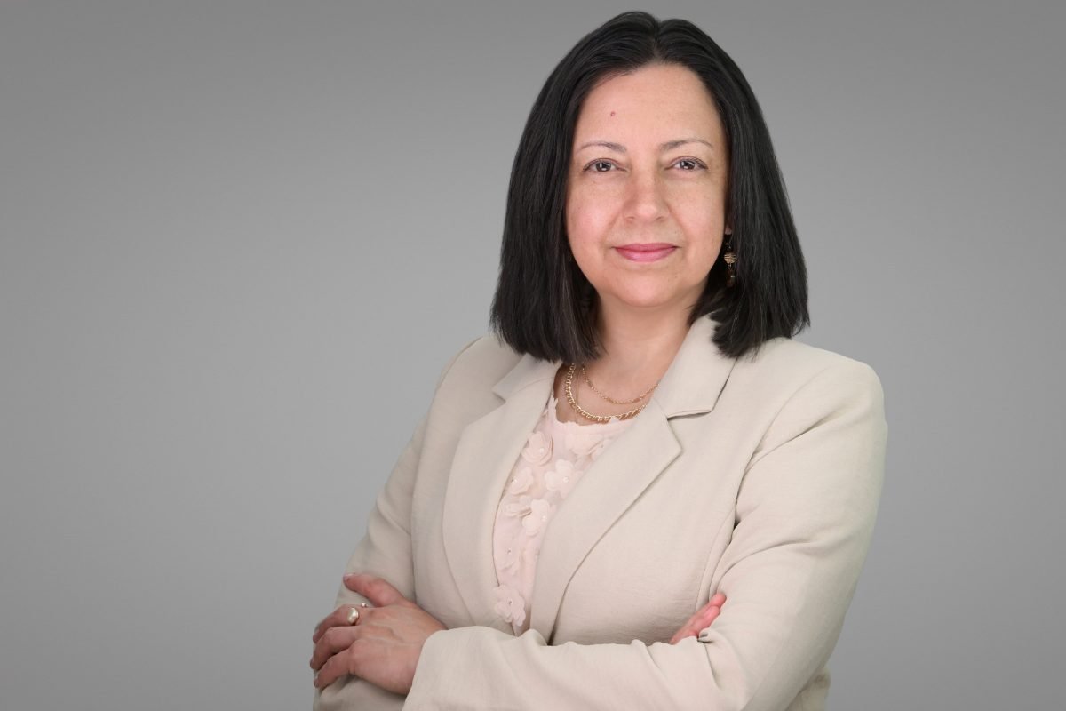Professional headshot of Claudia Barbosa photographed on a light backdrop