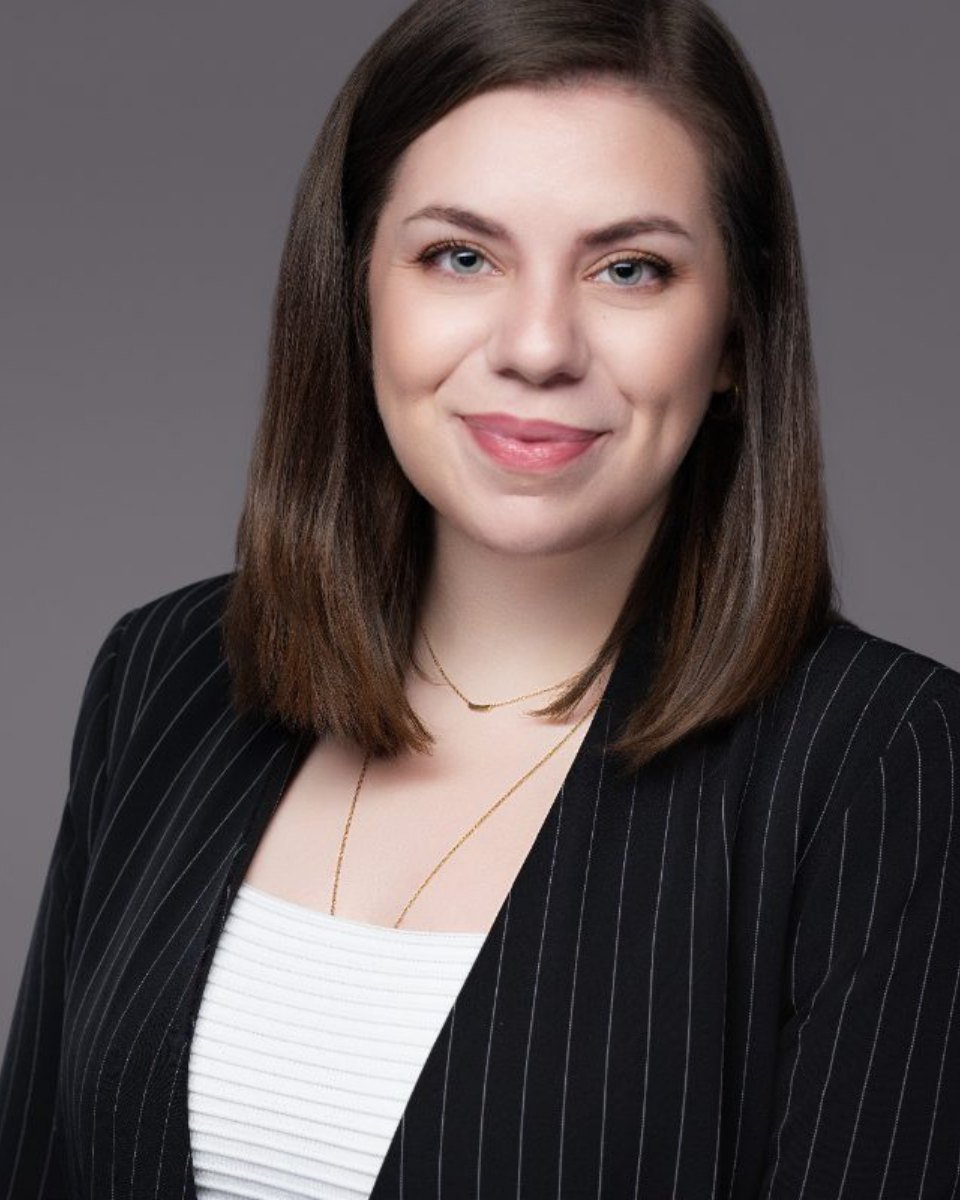 Professional headshot of Ester Gherea photographed on a grey backdrop in Langley