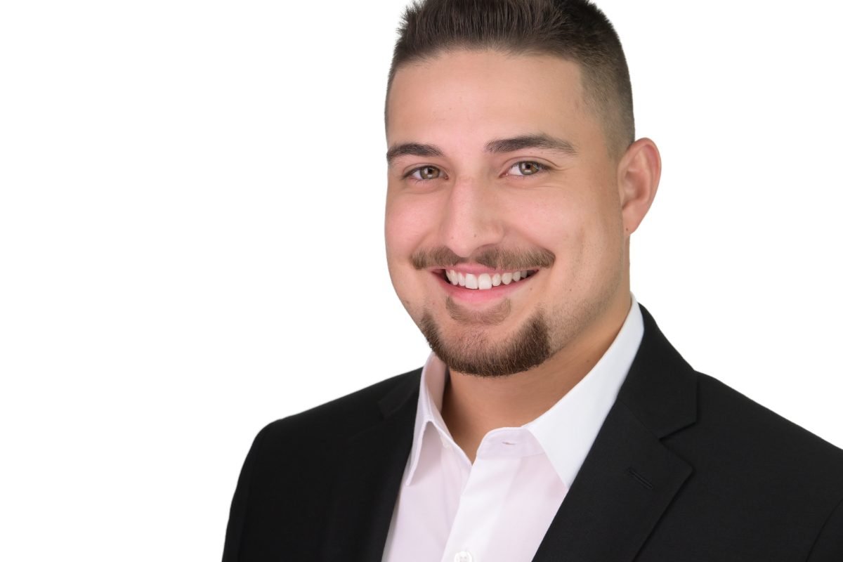 Professional headshot of Ethan Quinn photographed on a white background