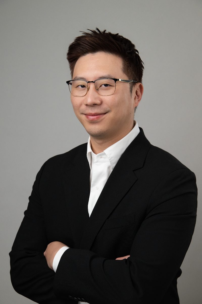 Professional headshot of Jae Han on a dark studio backdrop, Vancouver area