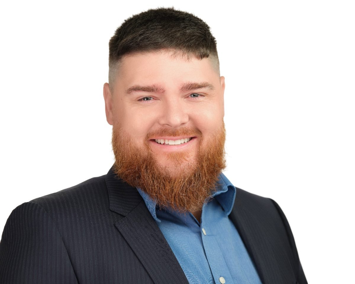 Professional headshot of Przemek Cerazy on a white background, Surrey area