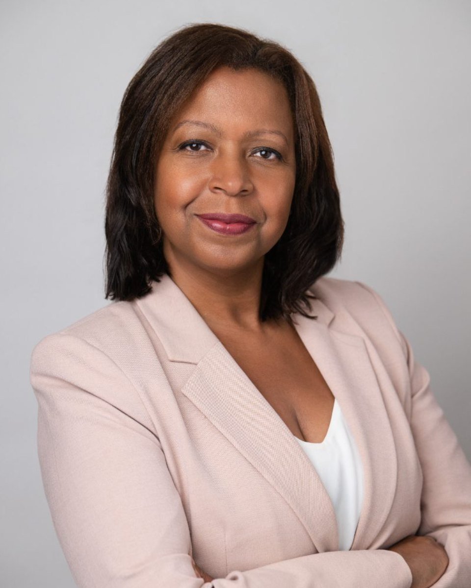Professional headshot of a woman in a pink blazer photographed in Langley BC