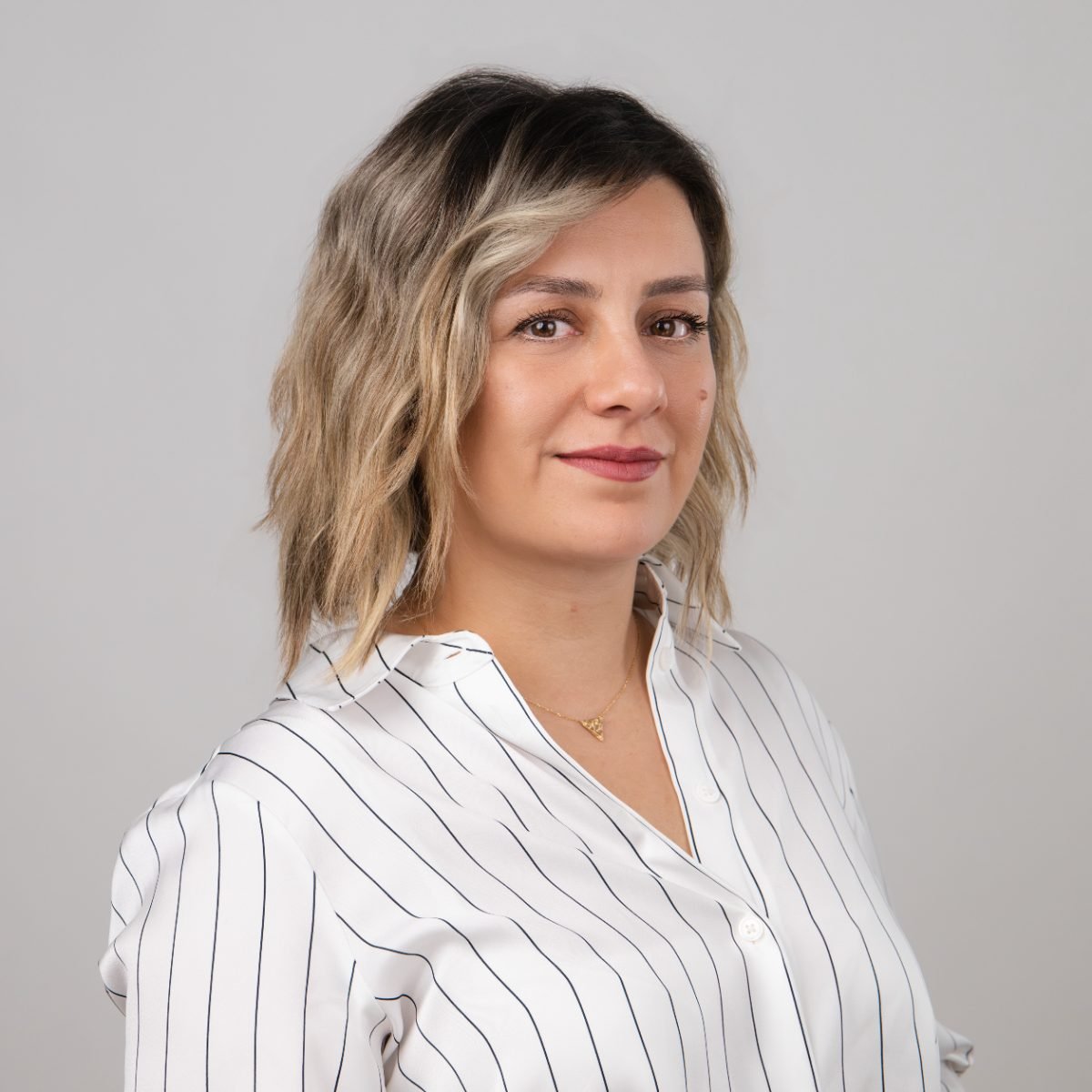 LinkedIn headshot of a woman in a striped blouse, Vancouver and Lower Mainland