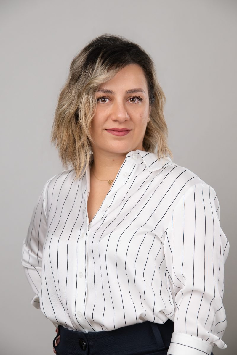 Professional LinkedIn headshot of a woman in a striped shirt, Langley studio