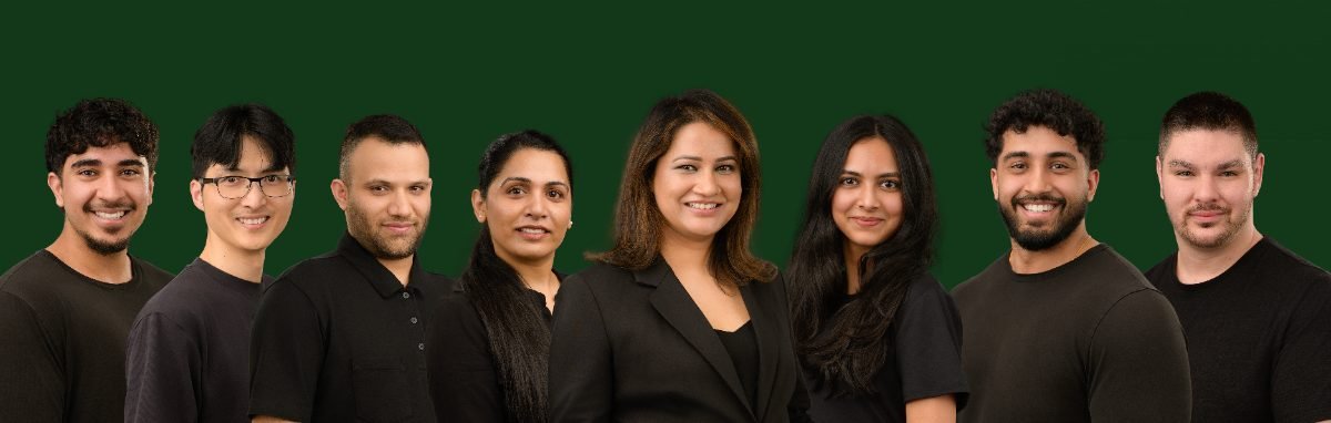 Group team photo of the Willow Wellness Group photographed on a dark background