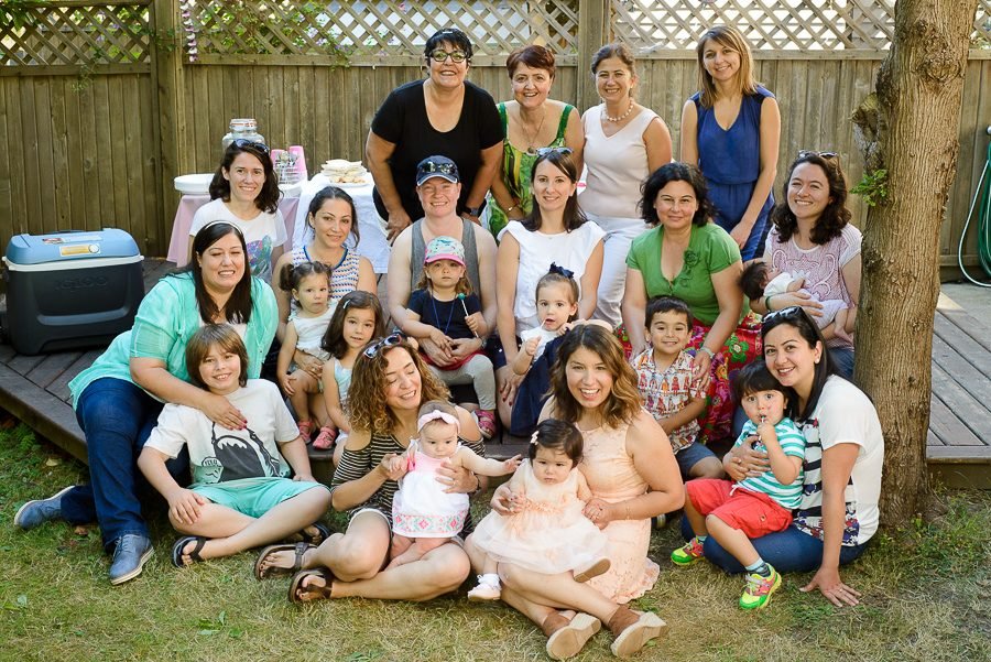 Baby shower group photo of guests gathered together in a backyard in the Lower Mainland