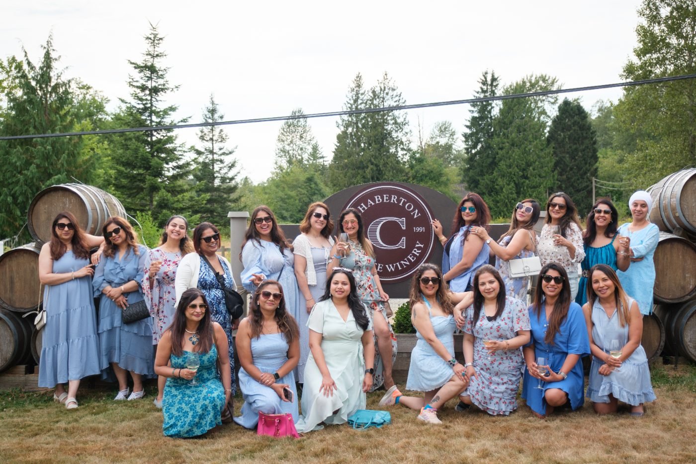 Bridal shower group photo of guests in matching blue dresses at a Fraser Valley winery