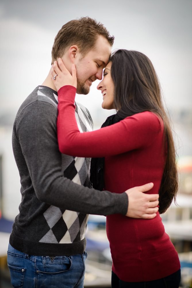 Engagement session portrait of a couple forehead to forehead at a Vancouver marina