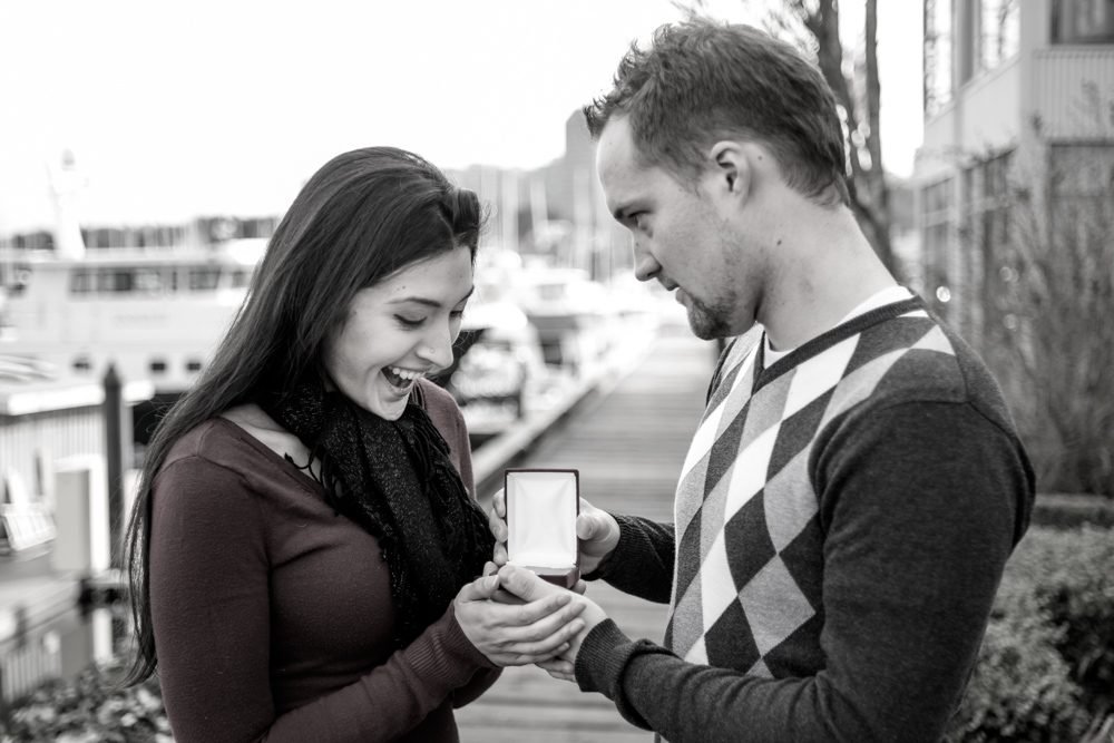 Surprise marriage proposal photographed at a marina as she sees the ring for the first time