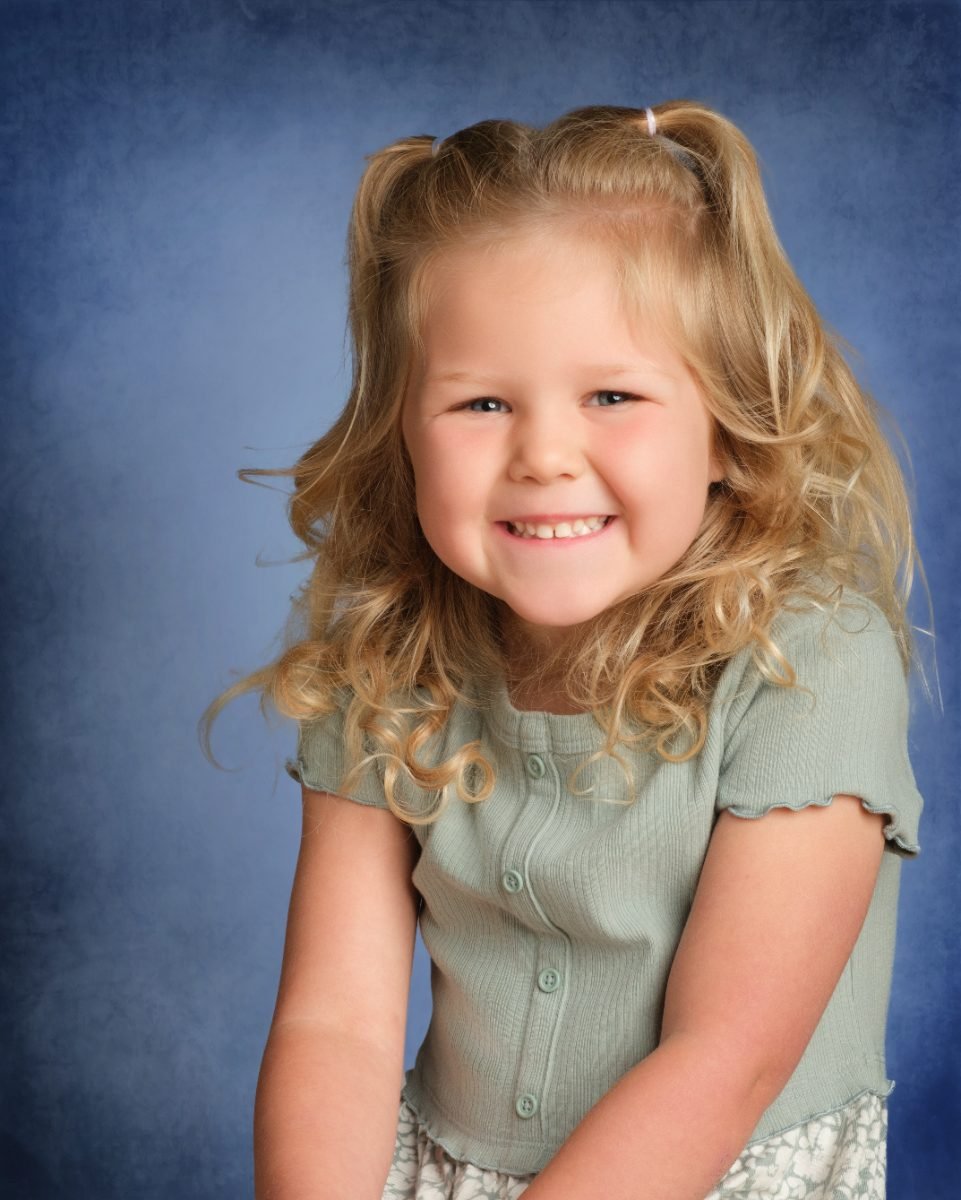 A school portrait on the traditional blue picture-day backdrop