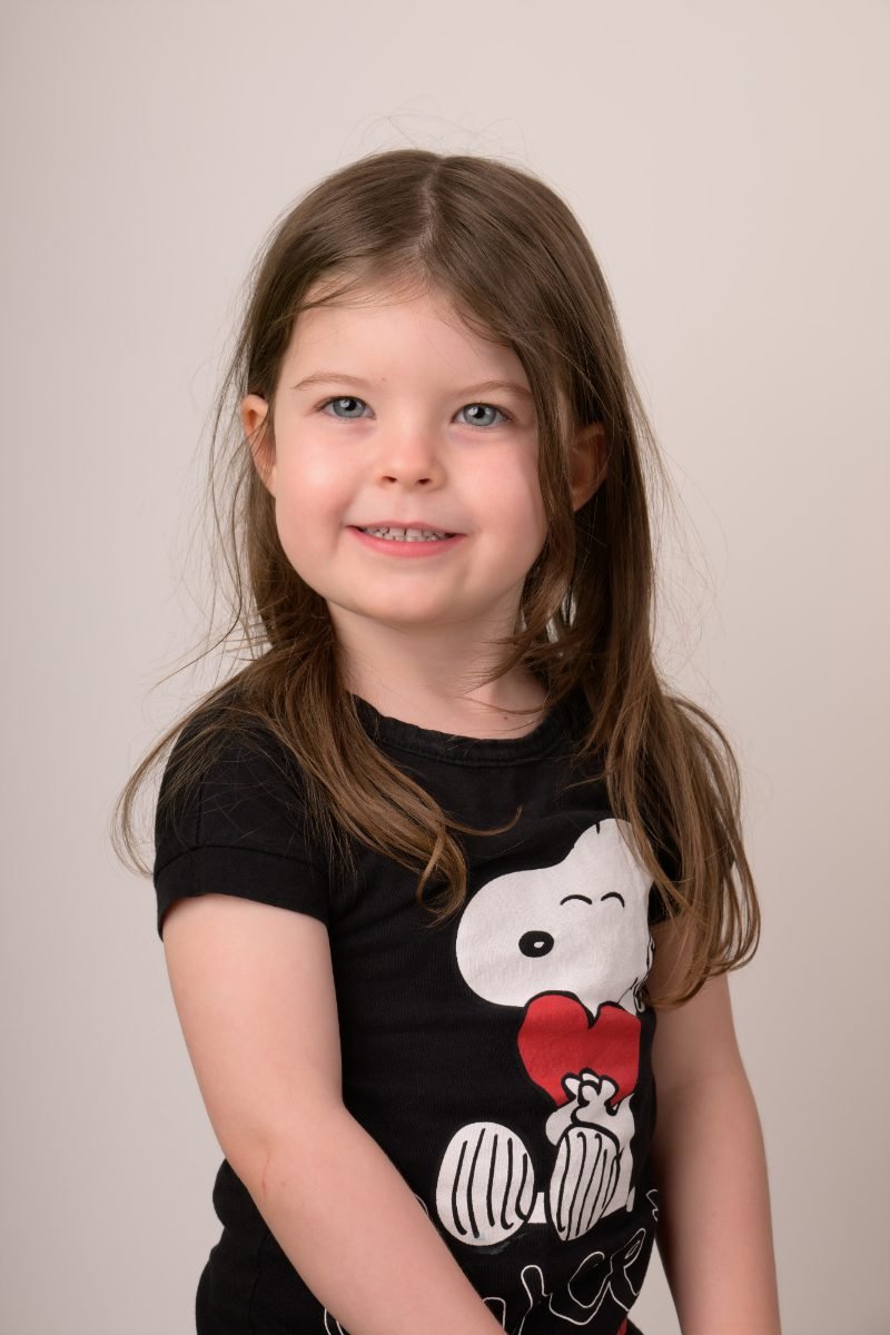A girl in a black graphic tee with her shoulder turned