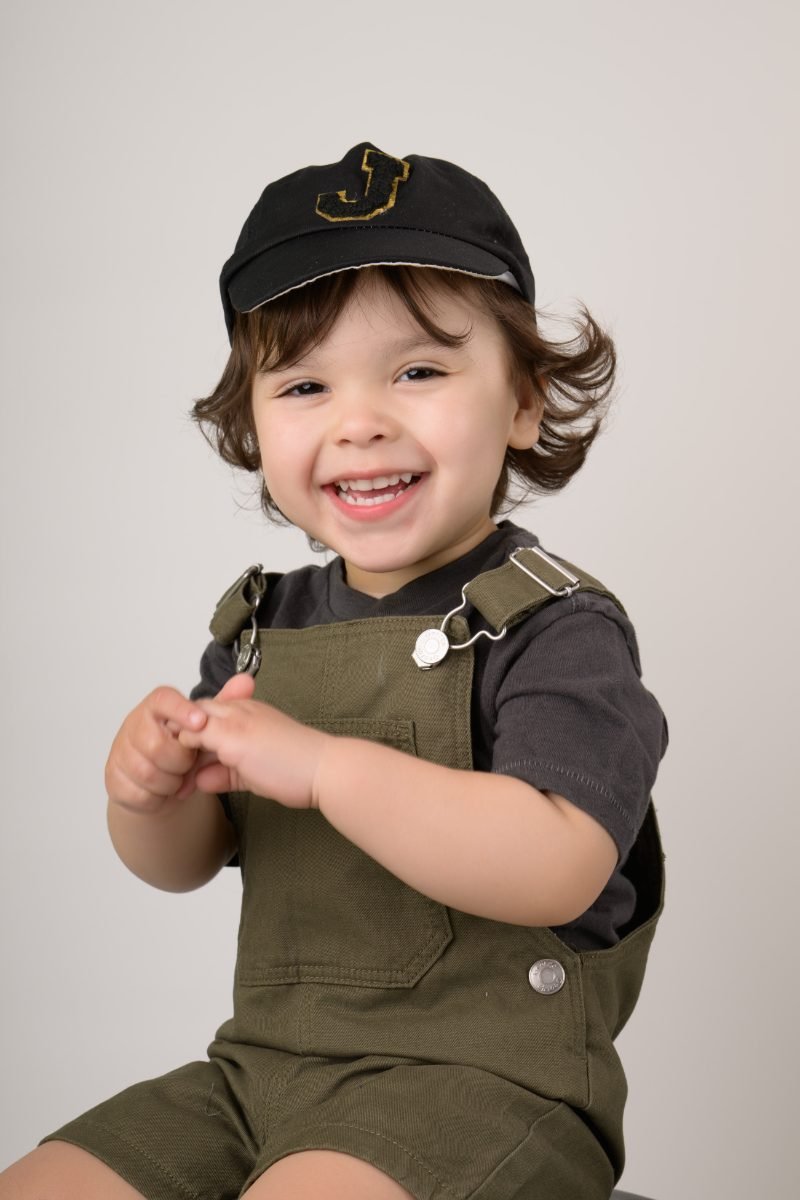 The same boy clapping and laughing mid-session