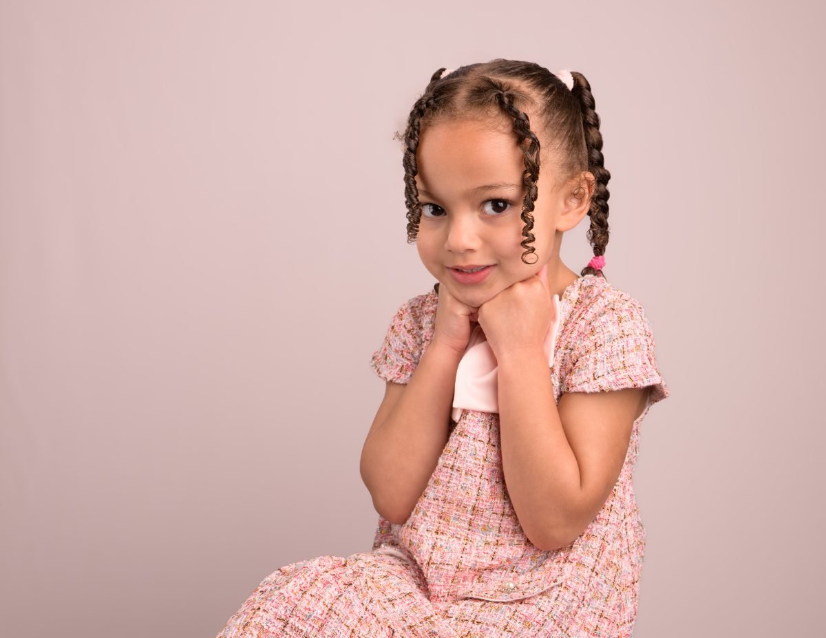 The same girl with a hand resting at her cheek
