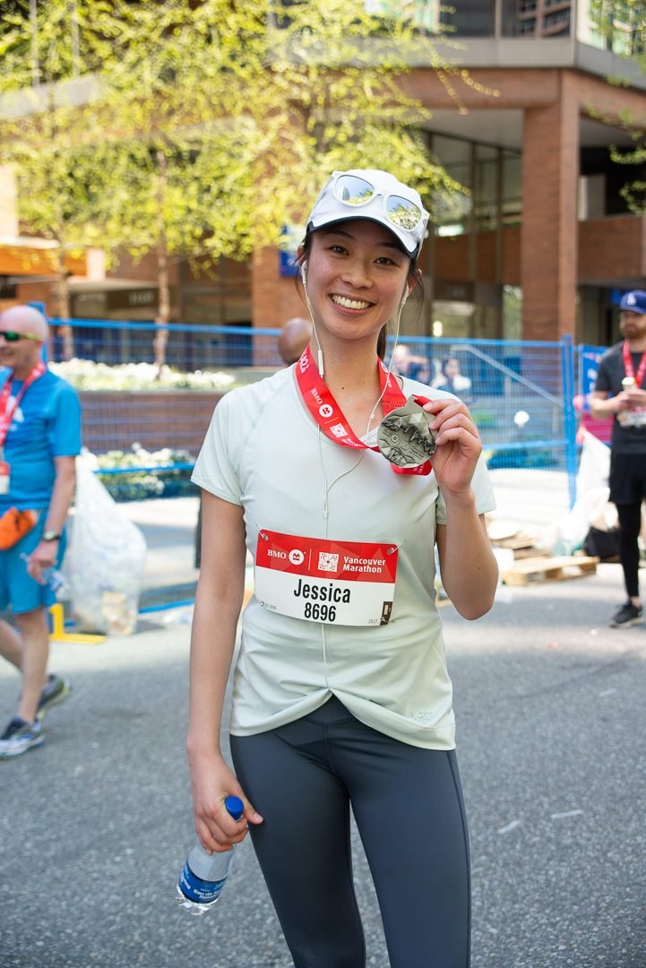 Marathon finisher portrait with a race medal after the finish line