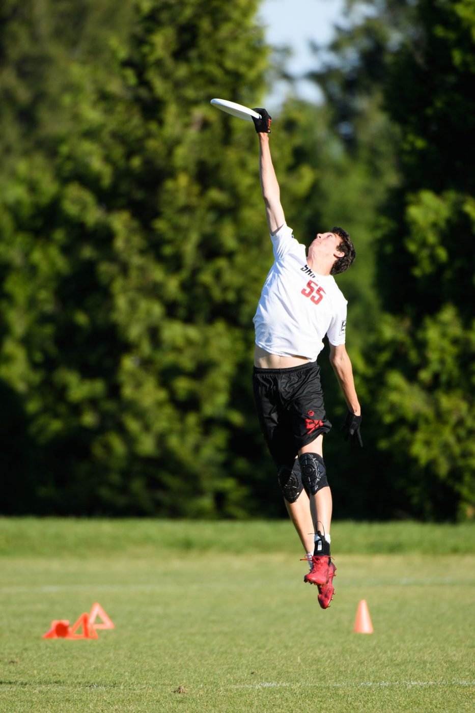 Ultimate frisbee player laying out for a full extension catch
