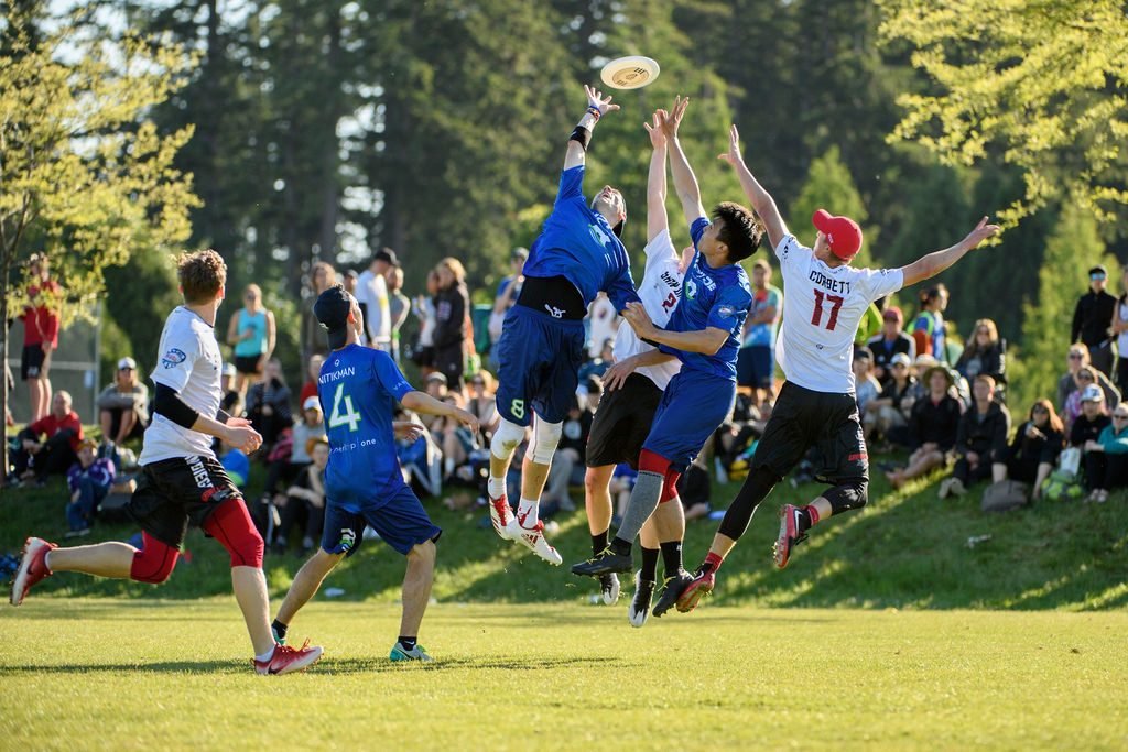 Ultimate frisbee teams competing for the disc at a tournament