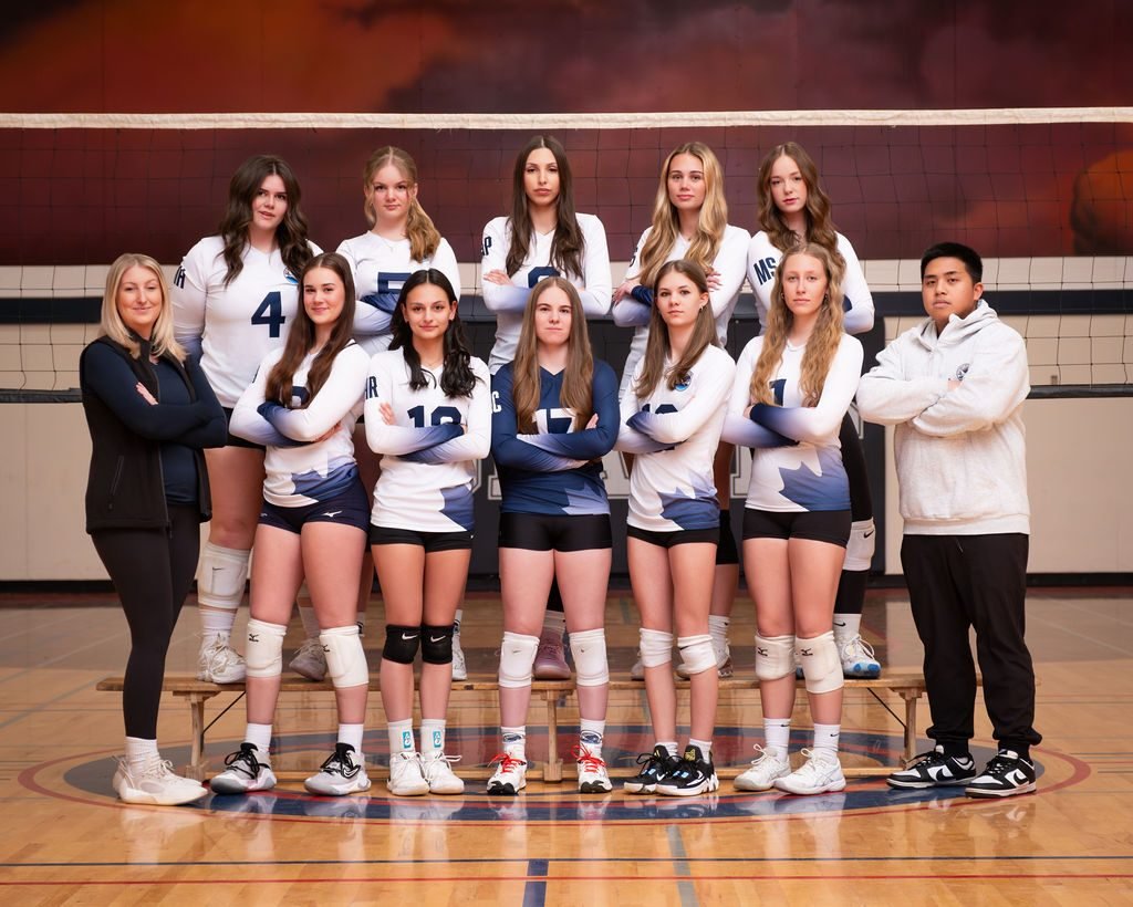Rep volleyball team photo lined up on court in navy game kit