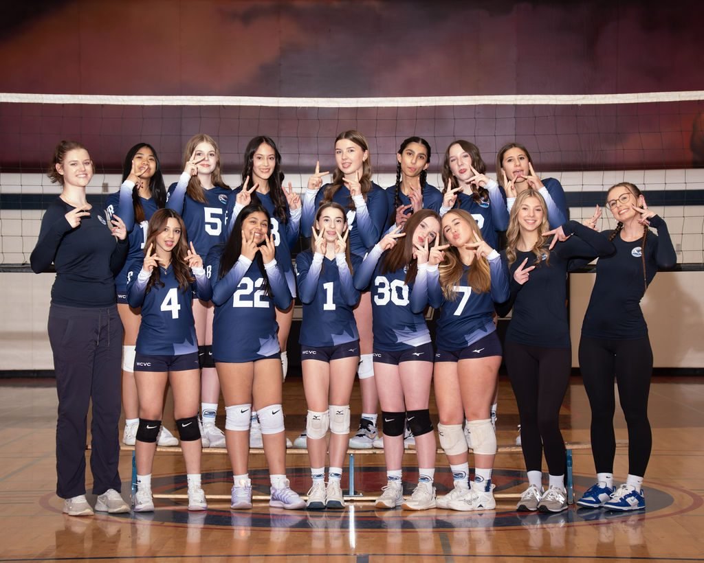Volleyball team photo with players in white and navy club uniforms