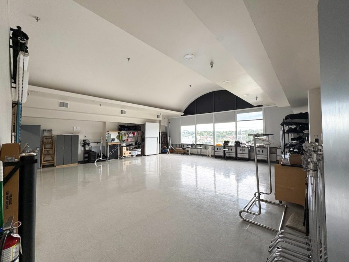 Vancouver studio interior with a wall of windows over the city and a prep area along the side